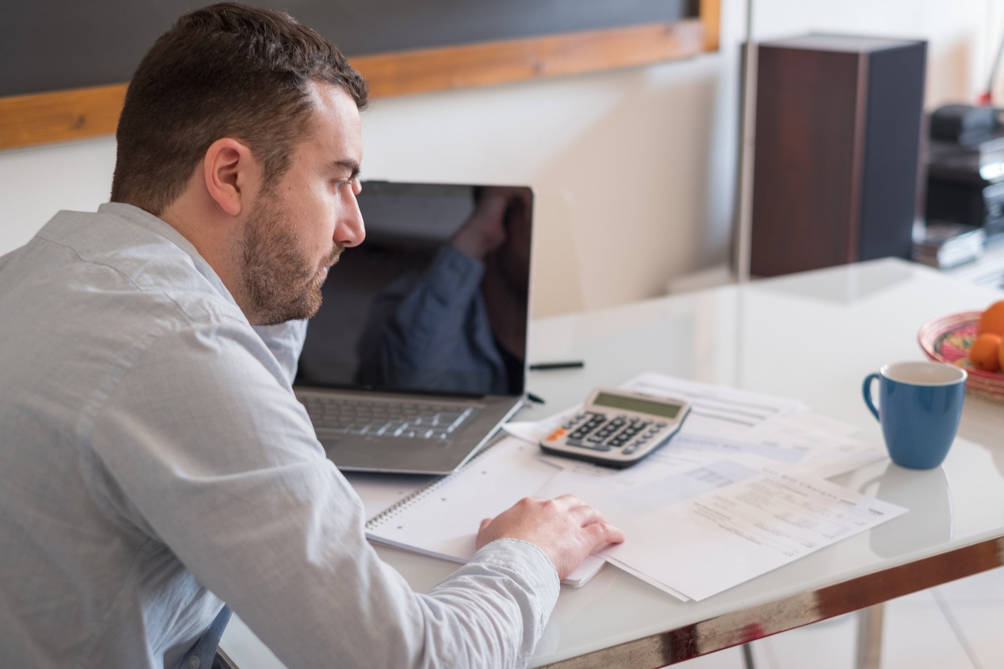 Man seated at a desk and analyzing documents
